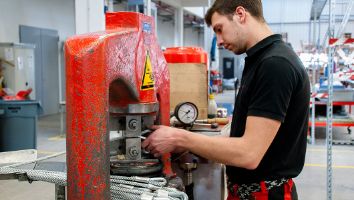 Ein Mann beim Verpressen von dünnen Drahtseilen